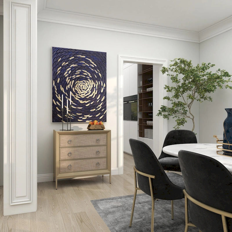 Commode 3 tiroirs en bois beige, avec finition capitonnée, plateau miroir et poignées anneaux.