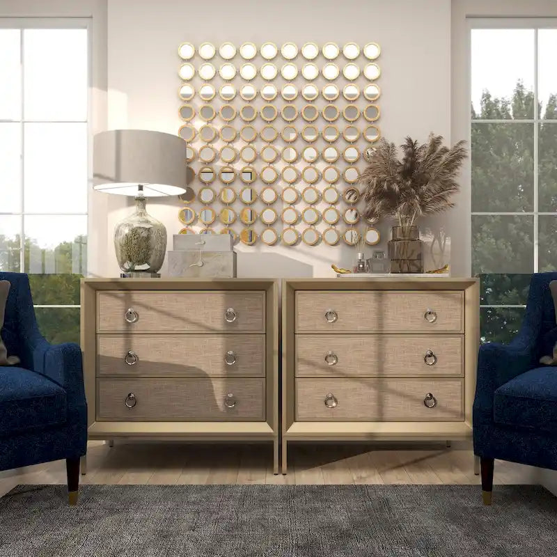 Commode 3 tiroirs en bois beige, avec finition capitonnée, plateau miroir et poignées anneaux.