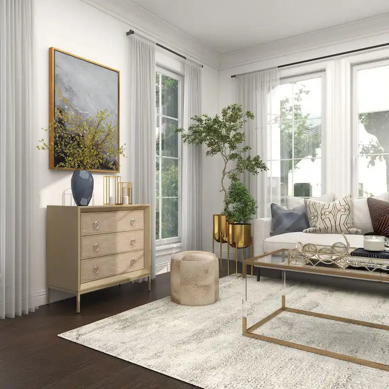 Commode 3 tiroirs en bois beige, avec finition capitonnée, plateau miroir et poignées anneaux.